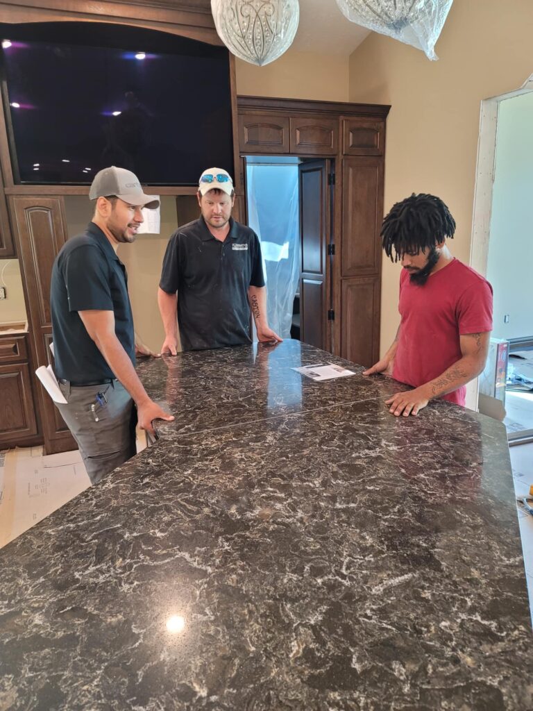 Workers observing a countertop installation